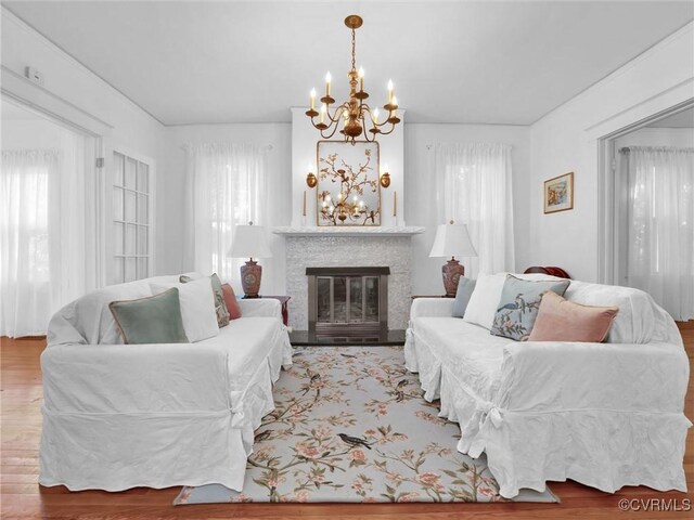 110 Gatewood Ave, Crewe, VA 23930 - living area featuring a chandelier, a glass covered fireplace, and wood finished floors
