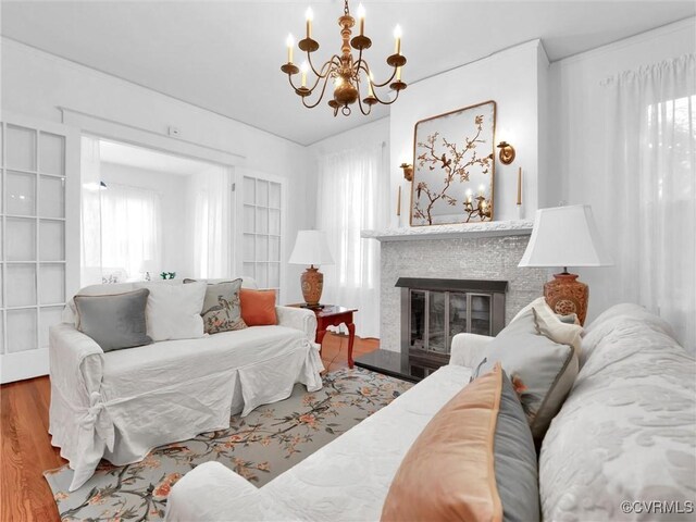 110 Gatewood Ave, Crewe, VA 23930 - living room with a chandelier, wood finished floors, and a glass covered fireplace