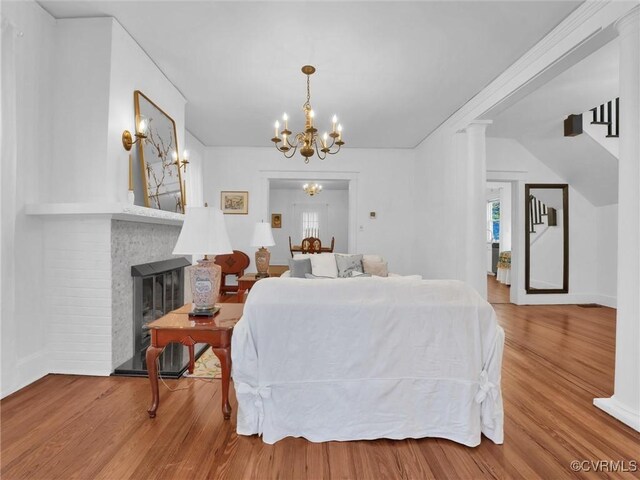 110 Gatewood Ave, Crewe, VA 23930 - living area featuring wood finished floors, a chandelier, and a fireplace
