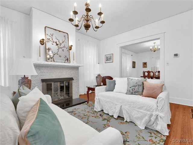 110 Gatewood Ave, Crewe, VA 23930 - living room with a chandelier, wood finished floors, a glass covered fireplace, and baseboards