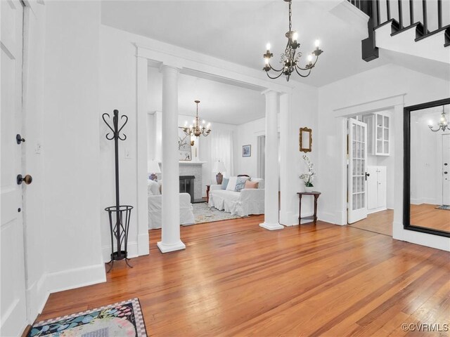110 Gatewood Ave, Crewe, VA 23930 - foyer entrance with a chandelier, light wood-style floors, baseboards, a glass covered fireplace, and stairs