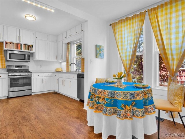 110 Gatewood Ave, Crewe, VA 23930 - kitchen featuring stainless steel appliances, wood finished floors, light countertops, and white cabinetry