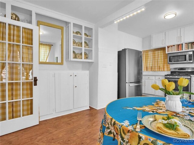 110 Gatewood Ave, Crewe, VA 23930 - kitchen featuring stainless steel appliances, wood finished floors, white cabinets, and glass insert cabinets