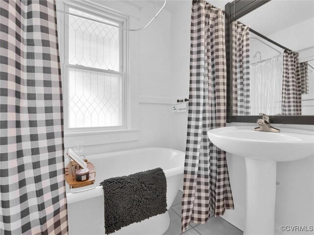110 Gatewood Ave, Crewe, VA 23930 - bathroom featuring a soaking tub, tile patterned flooring, and a sink