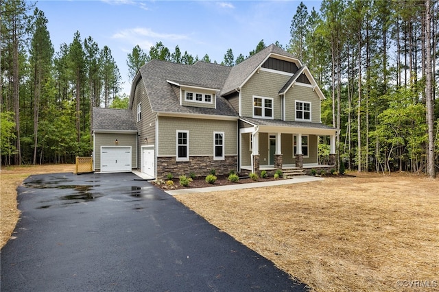 9496 Angels Share Dr, New Kent, VA 23124 - craftsman inspired home featuring covered porch, a garage, driveway, stone siding, and roof with shingles