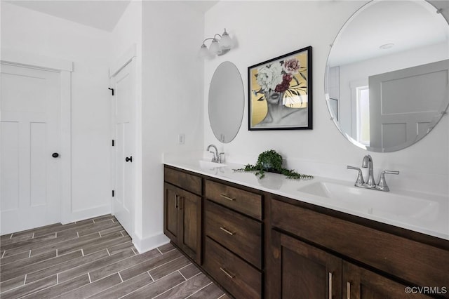 9496 Angels Share Dr, New Kent, VA 23124 - full bathroom with double vanity, wood finish floors, and baseboards