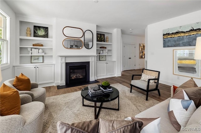 9496 Angels Share Dr, New Kent, VA 23124 - living area with a fireplace with flush hearth, wood finished floors, baseboards, and built in features