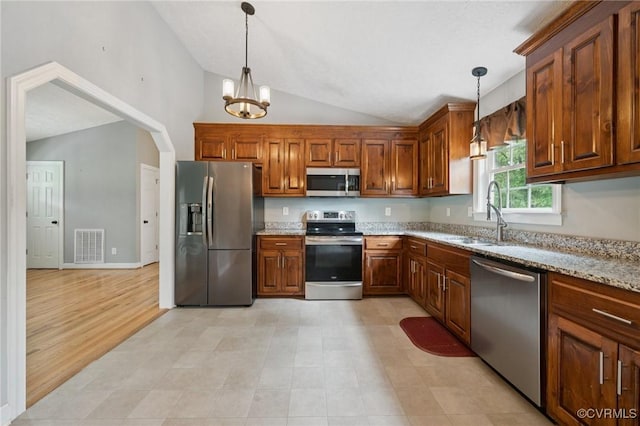 241 Deep Landing Rd, Tappahannock, VA 22560 - kitchen with stainless steel appliances, a sink, vaulted ceiling, a chandelier, and decorative light fixtures