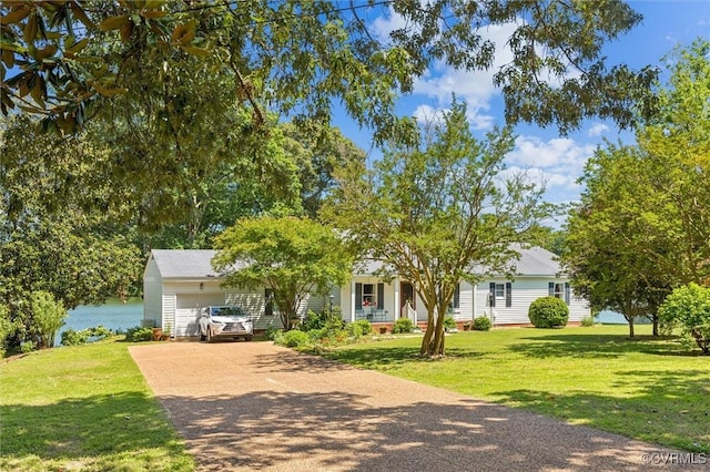 183 Nimcock Rd, Urbanna, VA 23175 - view of property hidden behind natural elements featuring an attached garage, driveway, and a front yard