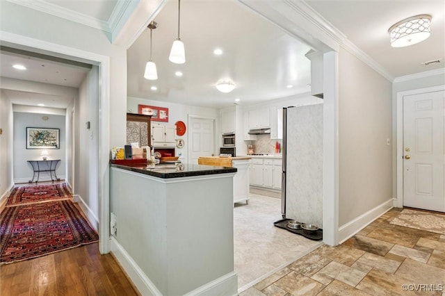 183 Nimcock Rd, Urbanna, VA 23175 - kitchen featuring freestanding refrigerator, under cabinet range hood, white cabinets, a peninsula, and tasteful backsplash