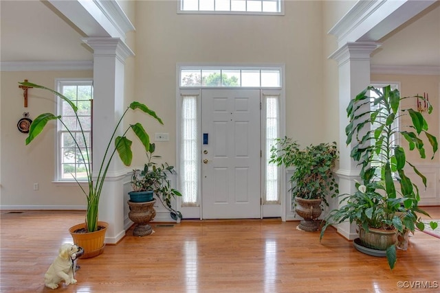 1306 Bach Ter, Chesterfield, VA 23114 - entrance foyer featuring decorative columns, wood finished floors, a high ceiling, crown molding, and baseboards