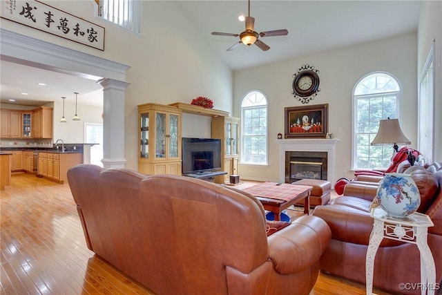 1306 Bach Ter, Chesterfield, VA 23114 - living room featuring a high end fireplace, high vaulted ceiling, ornate columns, healthy amount of natural light, and a ceiling fan