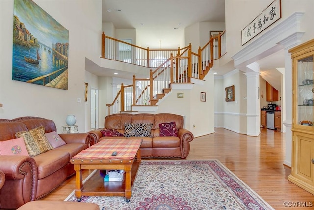 1306 Bach Ter, Chesterfield, VA 23114 - living room with light wood-style floors, a towering ceiling, stairs, and ornate columns