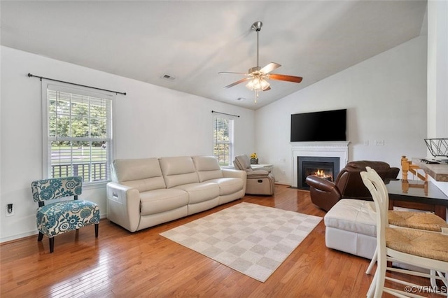2212 Sara Ann Ct, Aylett, VA 23009 - living area with vaulted ceiling, wood finished floors, a ceiling fan, and a fireplace with flush hearth