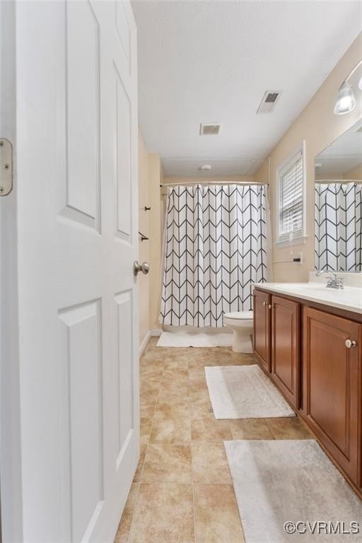 2212 Sara Ann Ct, Aylett, VA 23009 - bathroom with vanity, toilet, curtained shower, and tile patterned floors