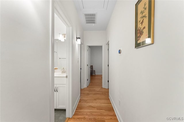 216 Edwin Cir, Aylett, VA 23009 - hallway with attic access, light wood-style floors, a sink, and baseboards