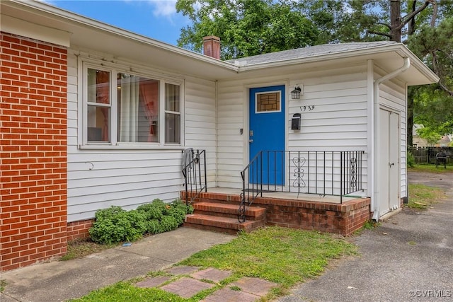 1939 Burks St, Petersburg, VA 23805 - property entrance with brick siding and a chimney