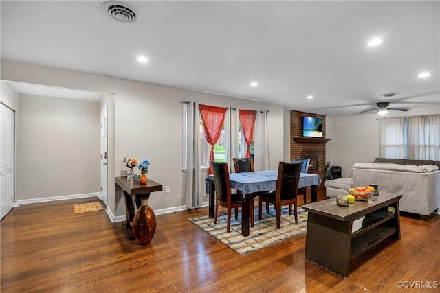 1939 Burks St, Petersburg, VA 23805 - dining space with dark wood finished floors, a brick fireplace, recessed lighting, ceiling fan, and baseboards