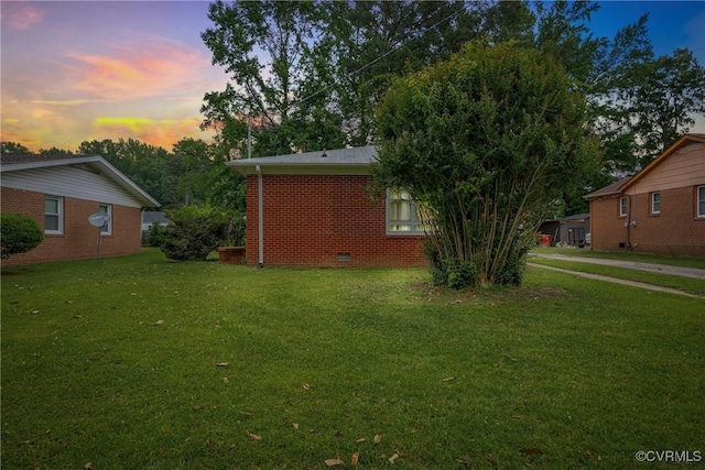 1939 Burks St, Petersburg, VA 23805 - property exterior at dusk featuring a yard, brick siding, and crawl space