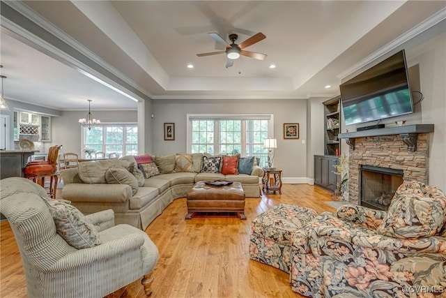 12700 Dell Hill Ct, Chester, VA 23831 - living area with ceiling fan, a raised ceiling, light wood finished floors, a fireplace, and a chandelier