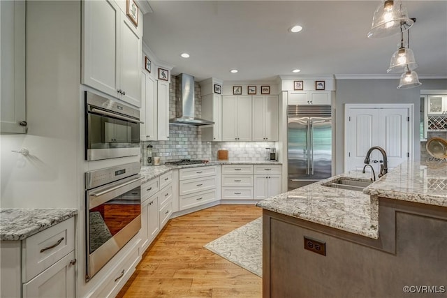 12700 Dell Hill Ct, Chester, VA 23831 - kitchen featuring appliances with stainless steel finishes, wall chimney range hood, a sink, tasteful backsplash, and crown molding