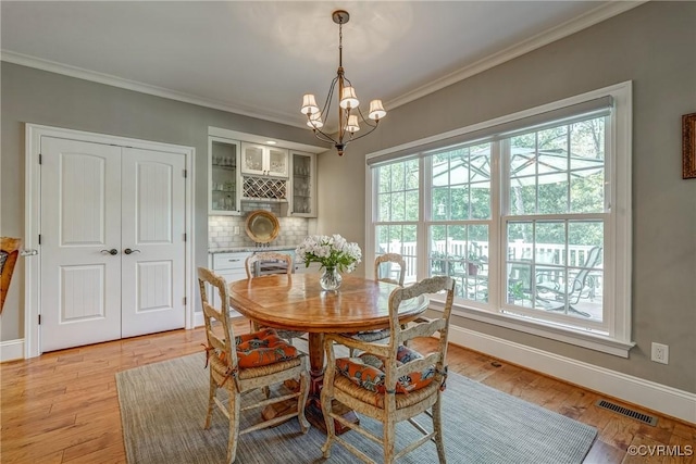 12700 Dell Hill Ct, Chester, VA 23831 - dining room featuring plenty of natural light, a chandelier, ornamental molding, and baseboards