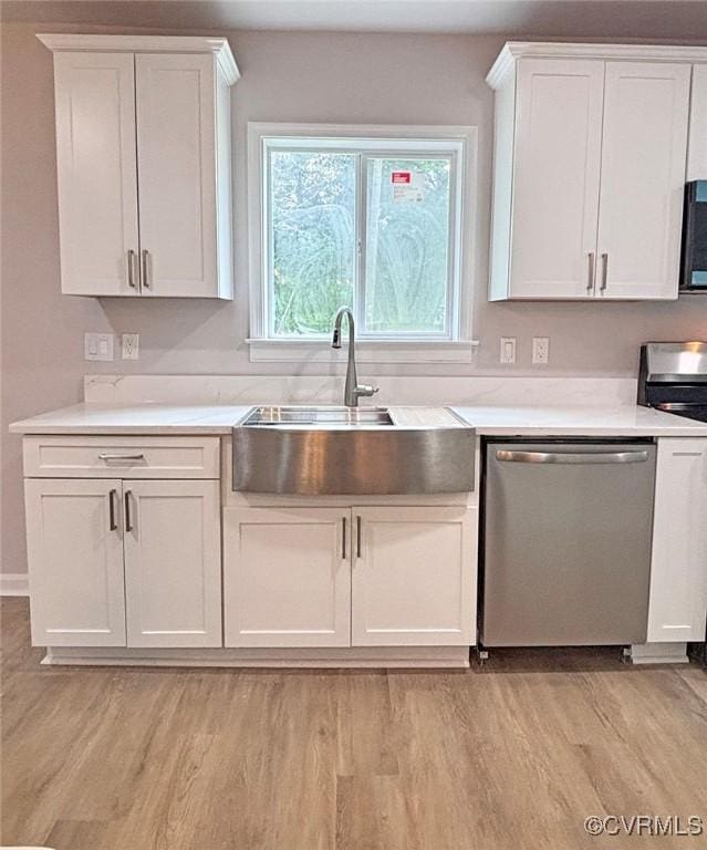 7906 Battlefield Park Rd, Henrico, VA 23231 - kitchen with appliances with stainless steel finishes, light wood-style floors, white cabinetry, and light countertops