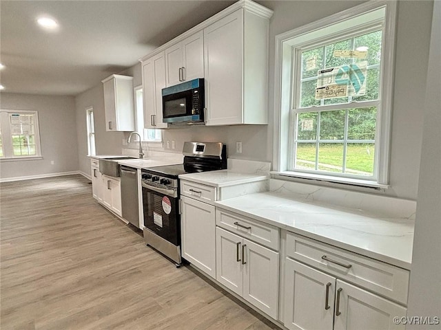 7906 Battlefield Park Rd, Henrico, VA 23231 - kitchen featuring stainless steel appliances, plenty of natural light, white cabinets, light wood-style flooring, and recessed lighting