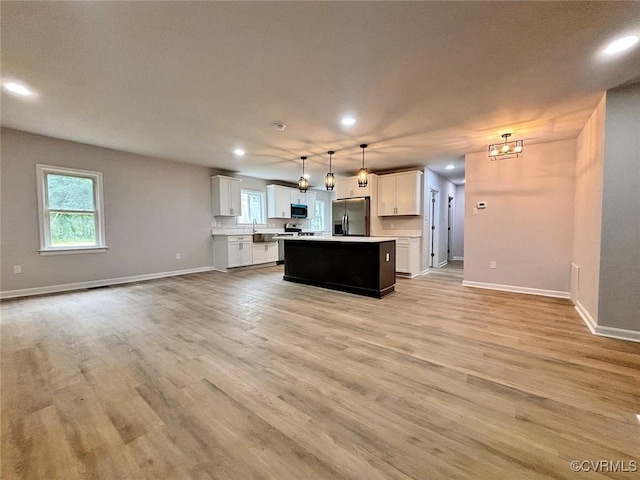 7906 Battlefield Park Rd, Henrico, VA 23231 - kitchen featuring stainless steel refrigerator with ice dispenser, black microwave, open floor plan, a center island, and recessed lighting