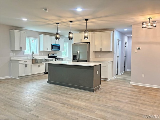 7906 Battlefield Park Rd, Henrico, VA 23231 - kitchen featuring stainless steel appliances, light countertops, recessed lighting, a kitchen island, and white cabinets