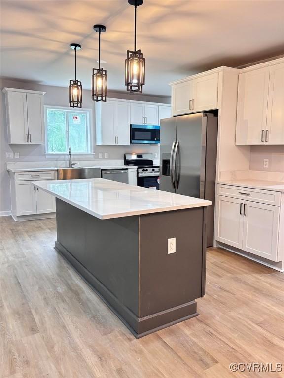 7906 Battlefield Park Rd, Henrico, VA 23231 - kitchen with appliances with stainless steel finishes, light wood finished floors, and light countertops