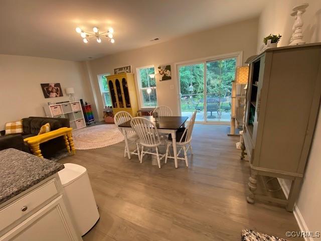 120 De La Warr Arch, Williamsburg, VA 23185 - dining space featuring wood finished floors and a chandelier