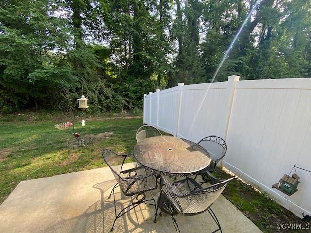 120 De La Warr Arch, Williamsburg, VA 23185 - view of patio / terrace with outdoor dining area and view of scattered trees