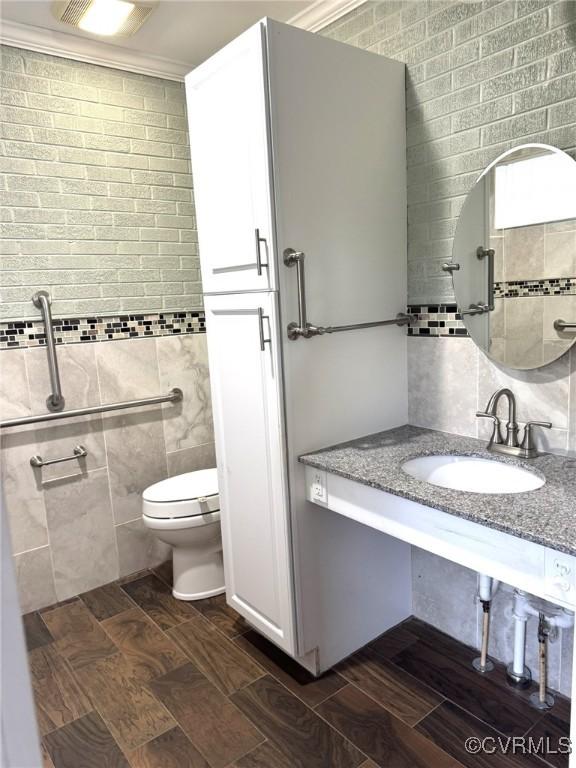 5404 Oak St, North Dinwiddie, VA 23803 - bathroom with tile walls, vanity, and wood tiled floors
