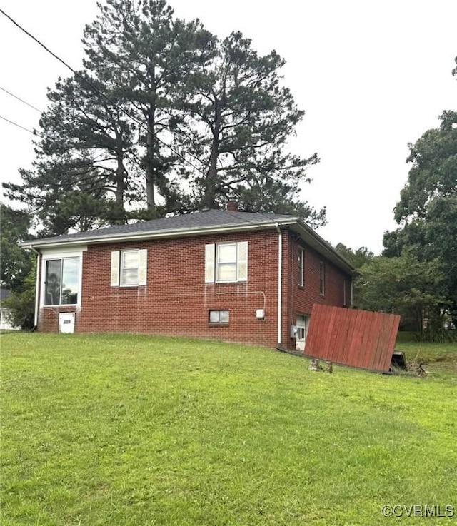 5404 Oak St, North Dinwiddie, VA 23803 - view of side of home featuring brick siding and a lawn
