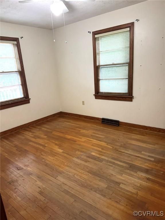 5404 Oak St, North Dinwiddie, VA 23803 - empty room with plenty of natural light, hardwood / wood-style floors, baseboards, and ceiling fan