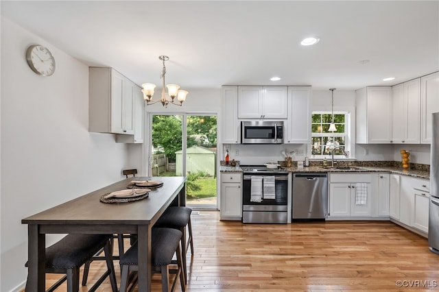 6124 Manuel Ct, Chesterfield, VA 23234 - kitchen with appliances with stainless steel finishes, a sink, plenty of natural light, a chandelier, and recessed lighting
