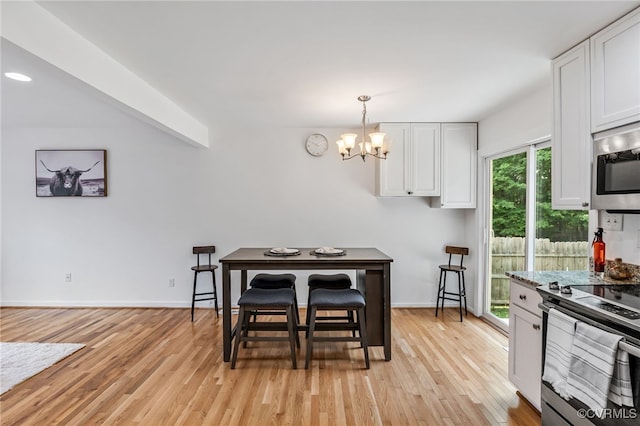 6124 Manuel Ct, Chesterfield, VA 23234 - dining area with a chandelier, light wood-style floors, and baseboards
