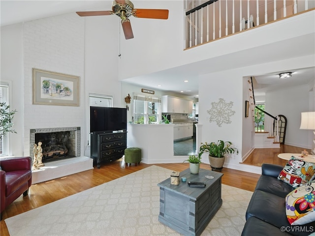 12503 Winchester Green Ct, Henrico, VA 23233 - living area with a ceiling fan, wood finished floors, stairway, a fireplace, and a high ceiling