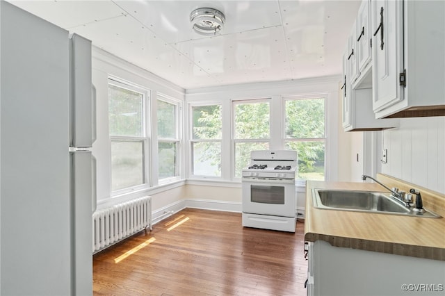 2707 Sherbourne Rd, Chesterfield, VA 23237 - kitchen featuring radiator, white appliances, and wood finished floors