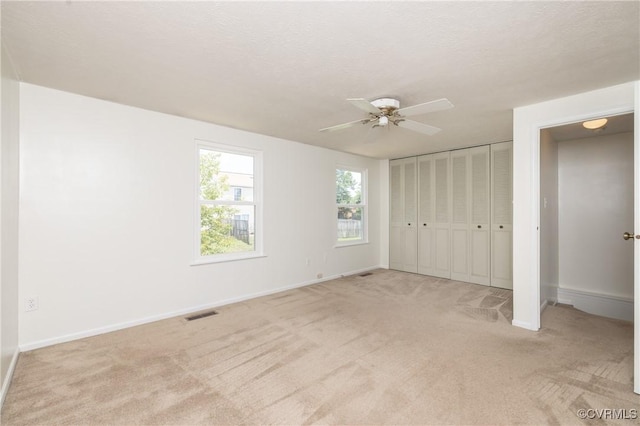 8406 Shannon Green Ct, Henrico, VA 23228 - unfurnished bedroom featuring light colored carpet, a ceiling fan, and a closet
