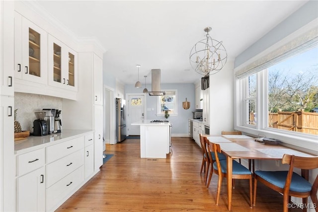 4100 Patterson Ave, Richmond, VA 23221 - dining space featuring light wood-type flooring, plenty of natural light, and a chandelier