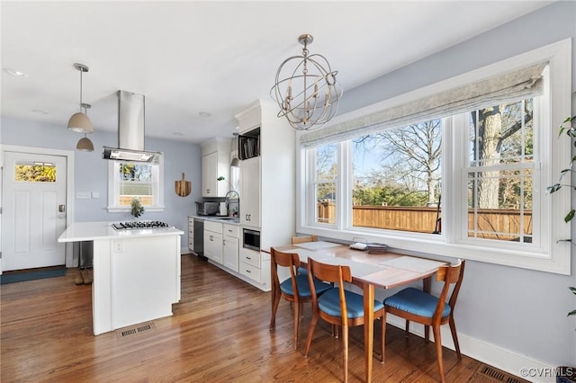 4100 Patterson Ave, Richmond, VA 23221 - kitchen with exhaust hood, healthy amount of natural light, light countertops, and appliances with stainless steel finishes