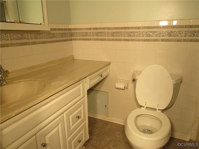 2803 Cannon Rd, Glen Allen, VA 23060 - bathroom featuring tile walls, vanity, wainscoting, and tile patterned floors