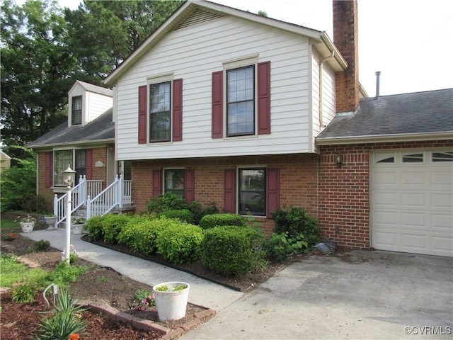 2803 Cannon Rd, Glen Allen, VA 23060 - split level home with a chimney, an attached garage, brick siding, and concrete driveway
