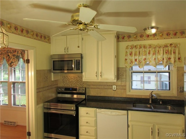 2803 Cannon Rd, Glen Allen, VA 23060 - kitchen featuring appliances with stainless steel finishes, a ceiling fan, plenty of natural light, and white cabinets