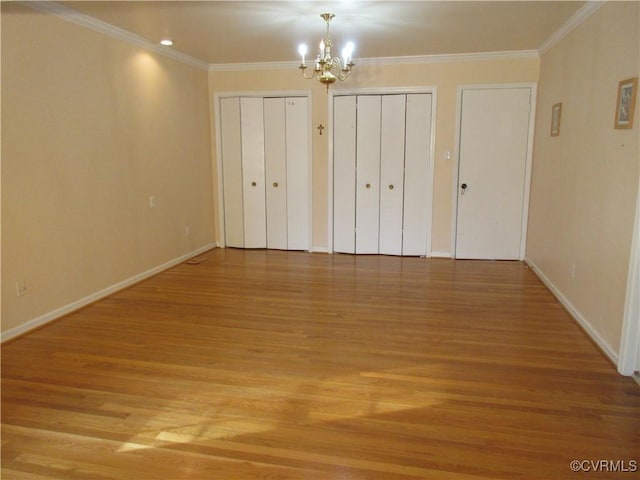 2803 Cannon Rd, Glen Allen, VA 23060 - unfurnished bedroom featuring multiple closets, a chandelier, light wood-style floors, and ornamental molding