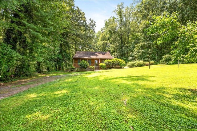 31 Pleasant Run, Cartersville, VA 23027 - view of green lawn featuring a view of trees