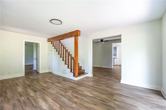 31 Pleasant Run, Cartersville, VA 23027 - empty room with stairway, wood finished floors, and a ceiling fan