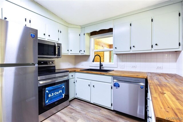 31 Pleasant Run, Cartersville, VA 23027 - kitchen featuring stainless steel appliances, butcher block counters, decorative backsplash, light wood-style flooring, and white cabinetry